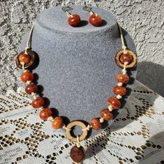 A Beautiful Beaded Custom Necklace With Matching Earrings. Made With Big Burnt Orange Beads And Is Very Well Made. This Is Handmade And One Of A Kind, There Are No Two Alike. Made With Love And Care. Let Me Know If You Have Any Questions . Elegant Orange Beaded Necklace With Wooden Beads, Orange Jewelry With Wooden Beads As A Gift, Orange Jewelry With Wooden Beads For Gifts, Bohemian Orange Necklaces With Wooden Beads, Unique Orange Jewelry With Wooden Beads, Orange Round Jewelry With Large Beads, Orange Wooden Beads For Jewelry Making, Orange Jewelry With Round Wooden Beads, Orange Wooden Beaded Jewelry