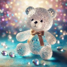 a clear teddy bear with a bow on it's neck sitting in front of some diamonds