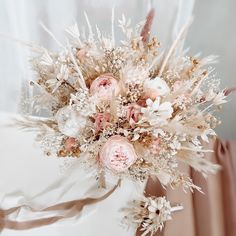 a bridal bouquet with pink and white flowers