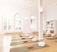 an empty room with yoga mats on the floor