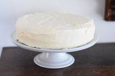 a white cake sitting on top of a wooden table