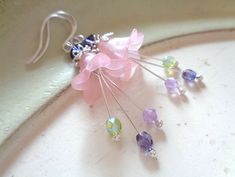 Alluring dangle flower earrings in Sterling silver only, with powdery pink or teal bell flowers in Lucite, and with 3 stamens dangling down from within in glittering beauty! These ANNALEAS FINEST earrings are made with Swarovski® crystals and are the safest solution for women with sensitive ears!  So romantic for elf and fairy dresses, for a wedding and many more occassions.  I handcraft the earwires and polish the ends round for best compatibility. Please come to my shop here: https://www.etsy. Whimsical Pink Dangle Flower Earrings, Whimsical Pink Earrings With Flower Charm, Whimsical Nickel-free Pink Earrings, Whimsical Pink Nickel-free Earrings, Whimsical Pink Flower Earrings For Pierced Ears, Whimsical Pink Flower Charm Earrings, Pink Whimsical Flower Earrings With Flower Charm, Pink Whimsical Flower Earrings For Pierced Ears, Pink Whimsical Flower Charm Earrings