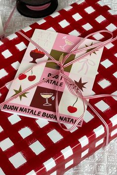 a red and white checkered table cloth with some tags tied to it