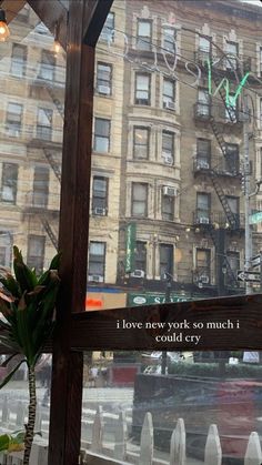 a window with a sign that says i love new york so much, could cry