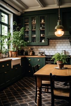 a kitchen with dark green cabinets and wooden table surrounded by potted plants on the counter