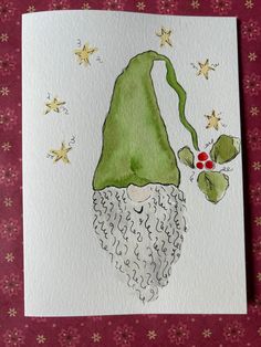 a card with an image of a green gnome's hat and stars on it