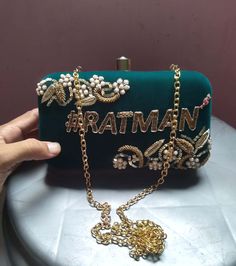 Customizable bridal embroidery clutch on Green velvet fabric. Color and name can be customized. Details : 1. 100% Hand embroidery 2. Material : Velvet 3. Dimensions : approximately 8*4 inches 4. Detachable long golden chain 5. Double side zardosi work and name also will be double side on the box. 6. Clutch Size 8*4 approx. Golden Clutch, Embroidery Clutch, Bridal Embroidery, Clutch Design, Hand Clutch, Zardosi Embroidery, Green Velvet Fabric, Zardosi Work, Black Clutch Bags