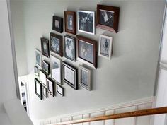 a staircase with many framed pictures on the wall