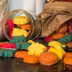 there are many candy candies in the jar and on the table next to it