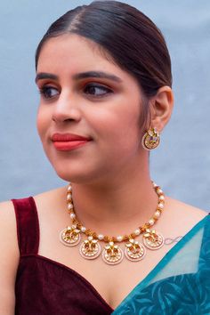 Description: Elevate your look with our Designer Gold Plated Kundan & Ruby Stone Necklace with Earrings. The intricate design and high-quality materials add a touch of elegance to any outfit. Perfect for special occasions or everyday wear, this set is a must-have for any fashion-forward individual. About: Eye-catching and unique jewelry that will set you apart. Gift this piece to a loved one, and see their face light up with joy. Best for gifting or for personal use, wear it to any occasion and Elegant Red Temple Necklace With Meenakari, Festive Round Jewelry Sets With Matching Earrings, Diwali Party Jewelry Sets, Festive Kundan Necklace With Matching Earrings, Diwali Jewelry Sets With Matching Earrings, Meenakari Jewelry Sets For Parties, Ruby Stone Necklace, Ruby Red Necklace, Saree Petticoat