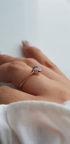 RING DETAILS: ✪Design: Gold ring ✪Gemstone: Natural tanzanite ✪Gemstone shape: Oval ✪Gemstone size: 4x6 mm ✪Gemstone weight: 0.45 ct ✪Gold weight: 1.1 grams ✪Setting type: Prong setting ✪Metal type: 14k solid gold ✪Metal finish: Smooth shiny Choose your ring size from drop down menu and if you need any other preferred ring size please contact us. QUALITY OF MATERIALS: Metal: Most of our jewelry at JewelryMansion is made with precious metals like gold and silver. These metals are 100% non-allergi Gold Tanzanite Birthstone Promise Ring, Tanzanite Diamond Ring Gift Round Cut, Tanzanite Round Cut Diamond Ring Gift, Fine Jewelry Yellow Gold Tanzanite Rings, Gift Tanzanite Diamond Ring With Round Cut, Round Cut Tanzanite Diamond Ring Gift, Tanzanite Birthstone Promise Ring, Gift Tanzanite Diamond Ring Round Cut, Tanzanite Birthstone Rings