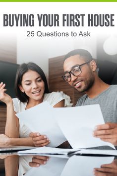 a man and woman looking at papers with the text buying your first house 25 questions to ask