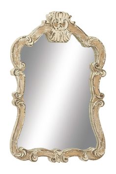 an ornate gold framed mirror on a white wall