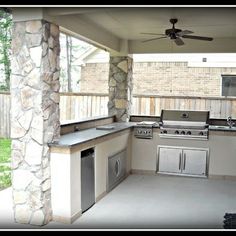 an outdoor kitchen with grill, sink and ceiling fan in the back yard or patio