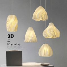 four white lamps hanging from the ceiling in front of a gray wall with text reading 3d printing