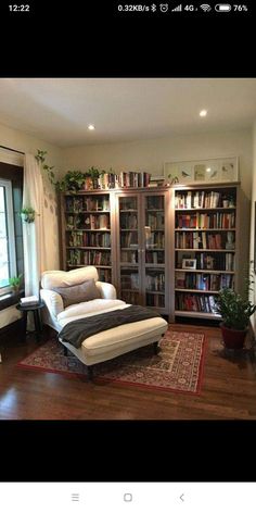 a living room filled with lots of furniture and bookshelves