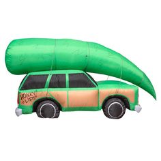 an inflatable car with a large green canoe attached to the roof is shown