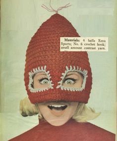 a woman wearing a crochet hat with eyeballs and eyelashes on her face