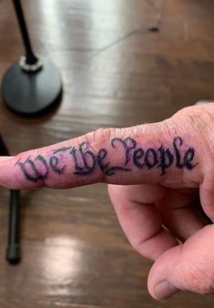 a person's finger with the words we are people written on it in black ink