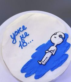 a white cake with blue frosting and an image of a person floating on the water