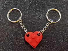 a lego heart shaped keychain on a black surface