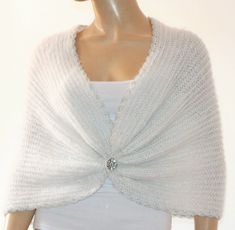 a mannequin wearing a white knitted shawl