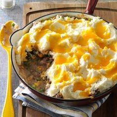 a casserole dish with mashed potatoes and meat