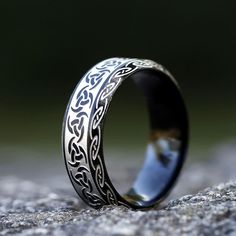 When worn, Odin's Horn Viking Ring is believed to have miraculous powers such as healing and protection against evil spirits. It is also thought to bring fortune and success in battle. The natural curved shape of the ring signifies the Horn of Odin, which was said to give off a great blast when blown by the Norse god himself. The Viking Ring is made from premium-quality stainless steel. It has an eye-catching and will never tarnish or oxidize. Great for men and women, it makes a great gift for l Black Symbolic Jewelry For Promise, Spiritual Black Jewelry For Promise, Symbolic Black Stainless Steel Rings, Black Stainless Steel Engraved Ring, Black Viking Engraved Jewelry, Spiritual Stainless Steel Ring, Adjustable Engraved Black Ring, Rune Ring, Nordic Symbols