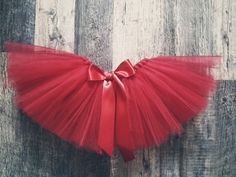 This pretty red tutu skirt is perfect to add to your little one's Valentine's Day, Christmas outfit, for her 1st Birthday, a cake smash photoshoot or just to dress up!!  It would also be a great gift as a baby shower gift!! The red tulle of the tutu is hand knotted on a red double sided satin ribbon to be tie in a bow at the back or the front.   I will need your little one's waist measurement, all around the waist where the tutu will sit. Waist up to 21". Length between 7" to 8"  CARE: ONLY spot Birthday Cake Smash Photoshoot, 1rst Birthday, Red Tutu Skirt, Girl Birthday Cake, Cake Smash Photoshoot, Smash Photoshoot, First Birthday Tutu, Christmas Tutu, Red Tutu