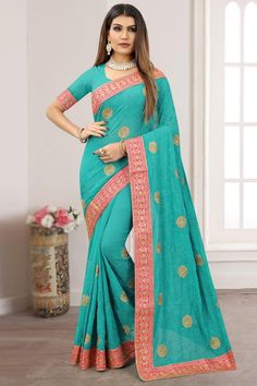 Exuding elegance and finished with perfection, this turquoise green georgette saree which will personify your grace.This u neck and half sleeve blouse is adorned with embroidered lace work at the sleeves.It is available with a georgette saree in turquoise green color embroidered with resham thread, zari, stone, and embroidered lace work t the border.This blouse can be customized up to the maximum size available in inches 58 around the bust. Slight color variation may occur due to photographic re Blue Color Saree, Navy Blue Saree, Trendy Saree, Reception Saree, Celebrity Gowns, Indian Sarees Online, Ready To Wear Saree