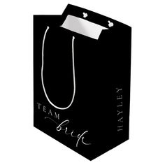 a black shopping bag with the words team bride on it's front and bottom