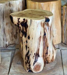 a wooden stool made out of tree stumps