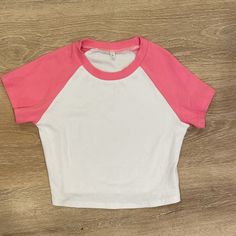 Halara Pink And White Ribbed Cropped Tee Shirt. Really Nice Stretch Material. It’s Cropped But Not Super Cropped. Can Be Worn As Athleisure To Work Out In But Looks Super Cute With Jeans! Size Large But Fits More Like A M/L Fitted White Color Block Crop Top, White Color Block Top For Summer, White Color Block Cotton Tops, White Cotton Color Block Tops, White Color Block Short Sleeve Top, Fitted White Color Block Top, White Color Block Tops For Spring, White Color Block Crew Neck Top, Cropped Tee Shirt