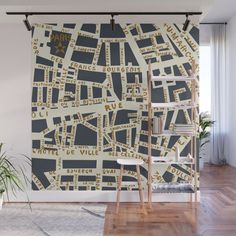 a large wall mural with gold and black street names on it's side in an apartment