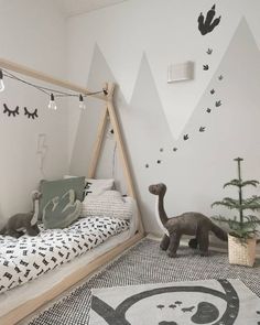 a child's bedroom decorated in black and white with an animal theme on the wall