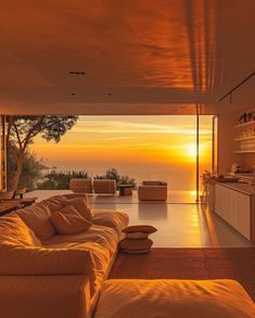 a living room filled with furniture and a sunset view