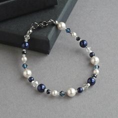 This navy and white bracelet is created using glass pearls, sparkling crystals and glass beads. The crystals really sparkle in the light and compliment the lustre of the pearls. Each dark blue pearl and crystal bracelet measures 18cm/7.25 inches in length and is finished with a gunmetal-plated lobster clasp. I have added a 1 inch extension chain to allow you to adjust your single strand bracelet to fit.  Your midnight blue jewellery will arrive carefully gift wrapped in the pretty, black box pic Chunky Stone Necklace, Chunky Pearl Necklace, White Pearl Jewelry, Silver Bar Earrings, Fused Glass Necklace, Fused Glass Earrings, Jewelry King, Pearl Gifts, White Bracelet