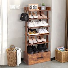 a wooden shoe rack with several pairs of shoes on it and two baskets next to it