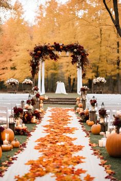 an aisle decorated with fall leaves and pumpkins