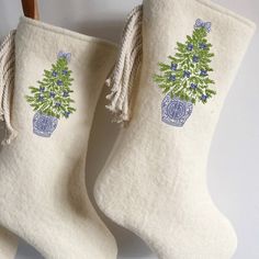 two white christmas stockings with blue and green decorations