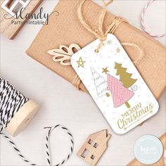 a christmas gift tag next to some crafting supplies