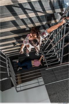 a man and woman are climbing up the stairs