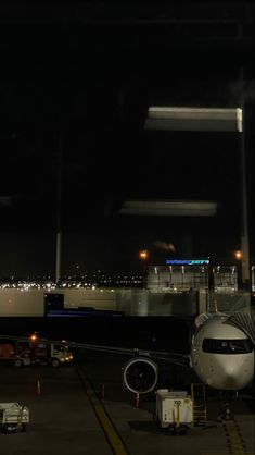 an airplane is parked on the runway at night