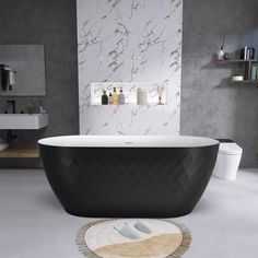 a bathroom with a white and black bathtub next to a rug on the floor