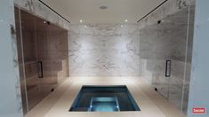 a large bathroom with marble walls and flooring