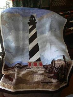 a crocheted blanket with a lighthouse on it