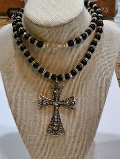 "This is a lovely and enviable necklace - wear it with your favorite outfits. This necklace is eye-catching, gorgeous, handmade one-of-a-kind Men Necklace with Flared Rhinestone Cross Pendant! The Antique Silver Pendant Length: 2 3/4\", Width: 1 15/16\". It is stringed with 8mm Jet Black Round Glass Bead and 6 mm Rondelle Glass Rhinestone Spacer Bead which adds a pop of excitement to the necklace.  Silver Plated 12 mm Lobster Clasp and Complete round Silver clasp Silver Express your style with O Beaded Cross Pendant Jewelry Gift, Beaded Cross Pendant Jewelry For Gift, Gift Necklaces With Bling And Round Beads, Gift Round Beads Bling Necklace, Bling Round Beads Necklace For Gift, Gift Bling Round Beads Necklaces, Cross Necklace With Silver Beads For Gift, Silver Beaded Cross Pendant Necklace, Beaded Cross Pendant For Jewelry Making