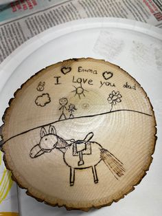 a piece of wood with an image of a horse on it that says i love you