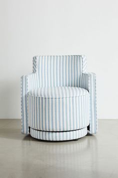 a blue and white striped chair sitting on top of a cement floor