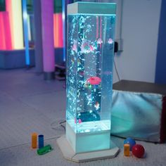 a fish tank filled with lots of different types of water and colorful balls on the floor